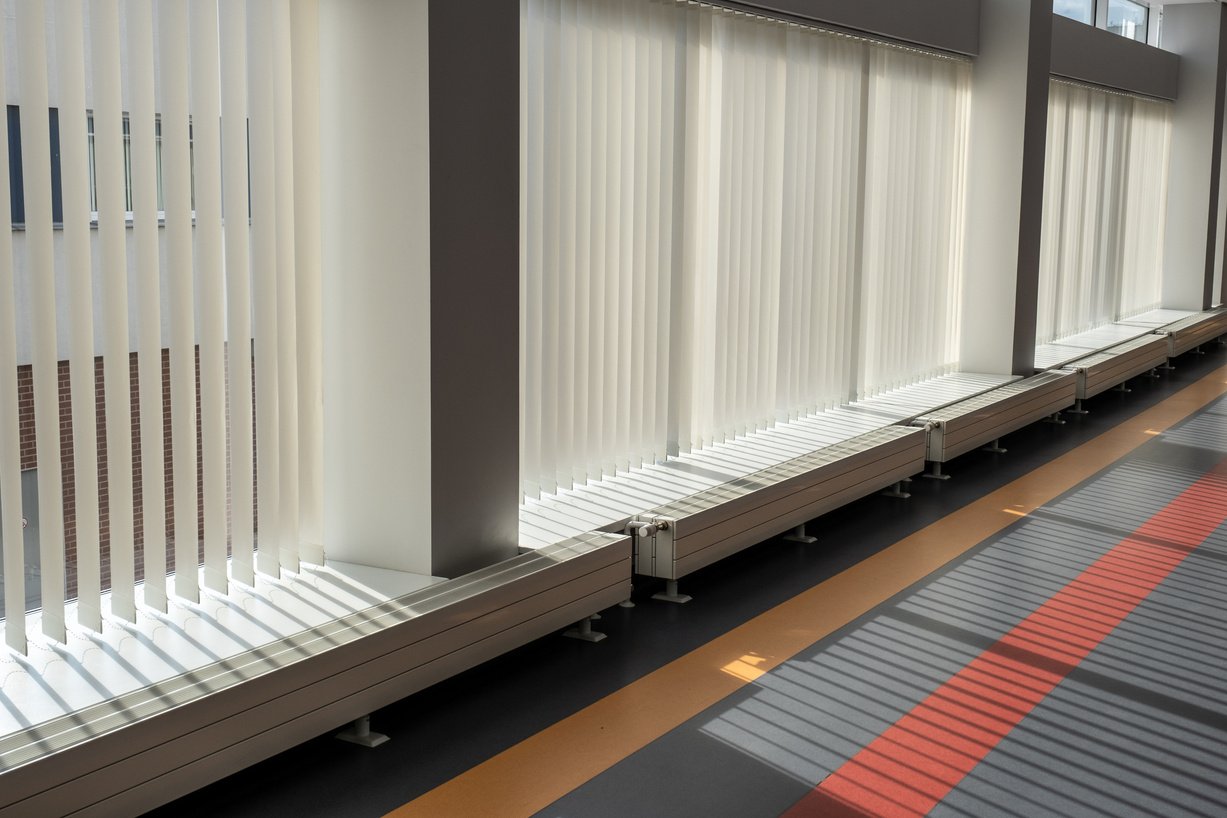 Large glass windows with vertical blinds in a modern building